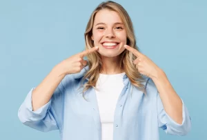 Patient pointing to her healthy smile in Canyon Country, CA